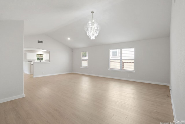 9814 Shawnee, Converse, TX 78109 - unfurnished living room featuring light wood-style flooring, a chandelier, vaulted ceiling, and baseboards