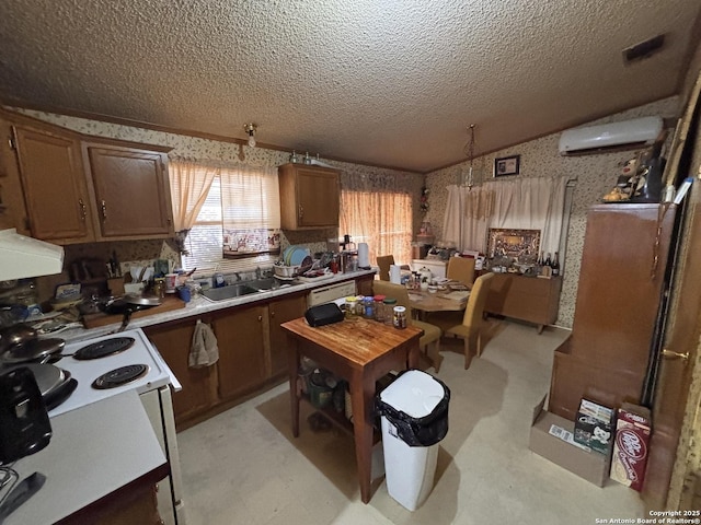 793 Fm 1986, La Pryor, TX 78872 - kitchen featuring an AC wall unit, wallpapered walls, a sink, lofted ceiling, and a textured ceiling