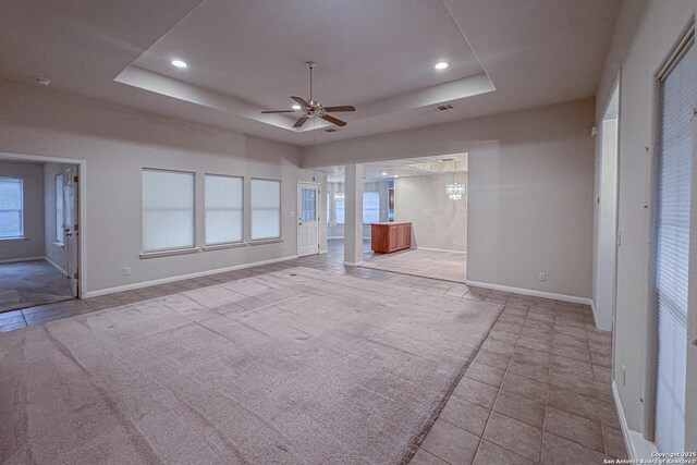 424 Mount Joy, New Braunfels, TX 78130 - unfurnished bedroom with a raised ceiling, baseboards, ensuite bath, recessed lighting, and tile patterned floors