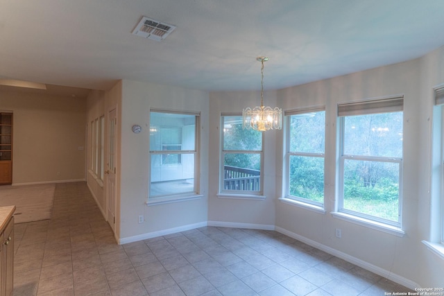 424 Mount Joy, New Braunfels, TX 78130 - unfurnished dining area with a chandelier, light tile patterned flooring, and baseboards