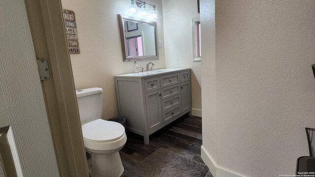 12151 Park Road 37, Lakehills, TX 78063 - bathroom featuring toilet, wood finished floors, and vanity