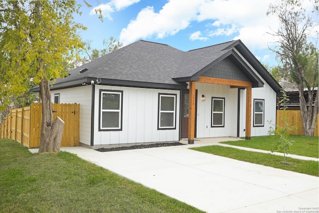 1526 Norfleet, San Antonio, TX 78208 - view of front facade with a shingled roof and board and batten siding