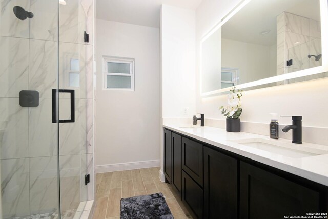 1526 Norfleet, San Antonio, TX 78208 - bathroom featuring double vanity, a marble finish shower, wood finish floors, and baseboards