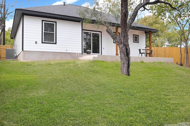 1526 Norfleet, San Antonio, TX 78208 - back of property with central air condition unit and a shingled roof