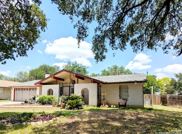 5819 Cayuga, San Antonio, TX 78228 - view of front of home featuring an attached garage, a chimney, and brick siding