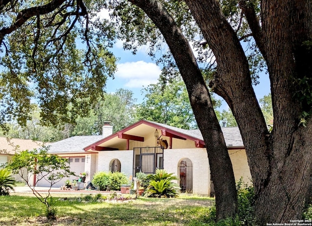 5819 Cayuga, San Antonio, TX 78228 - mid-century home with a chimney, brick siding, and roof with shingles