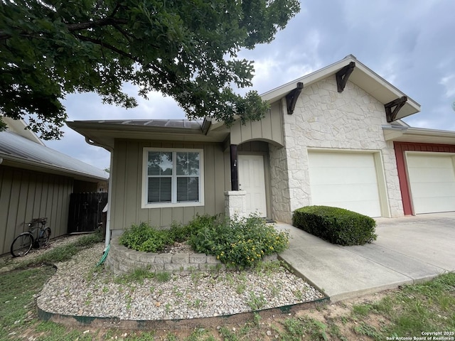 104 W W Unit 104, Comfort, TX 78013 - view of front of property with a garage, board and batten siding, stone siding, and driveway