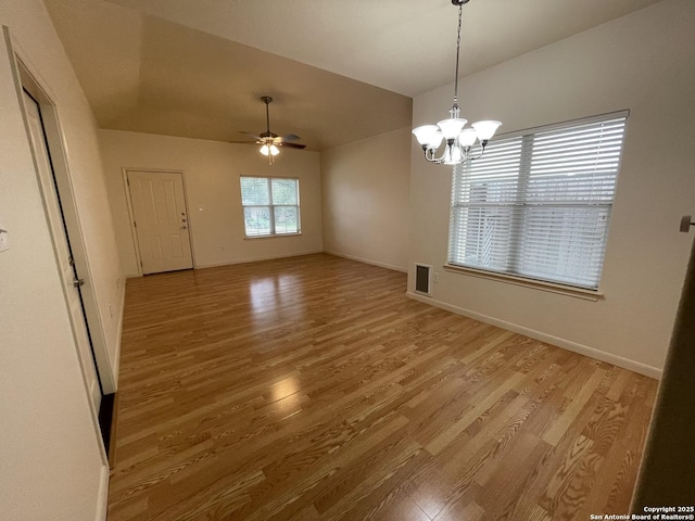 104 W W Unit 104, Comfort, TX 78013 - unfurnished dining area with light wood-style floors, vaulted ceiling, ceiling fan, a chandelier, and baseboards