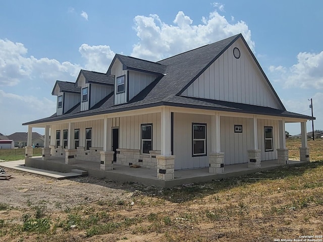 52 Peach Tree, Poteet, TX 78065 - view of front of property featuring roof with shingles, covered porch, and board and batten siding