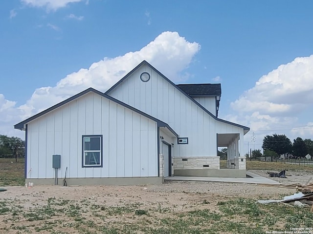 52 Peach Tree, Poteet, TX 78065 - rear view of property with board and batten siding