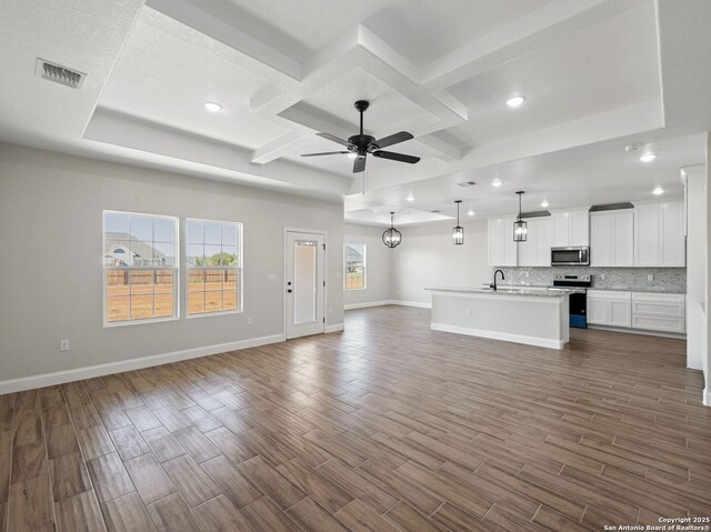 52 Peach Tree, Poteet, TX 78065 - unfurnished living room featuring coffered ceiling, ceiling fan, baseboards, dark wood-style flooring, and recessed lighting