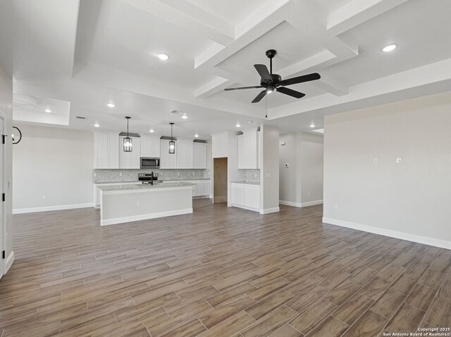52 Peach Tree, Poteet, TX 78065 - unfurnished living room featuring coffered ceiling, recessed lighting, baseboards, light wood-type flooring, and ceiling fan