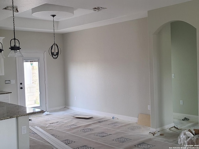 52 Peach Tree, Poteet, TX 78065 - unfurnished dining area featuring arched walkways and baseboards