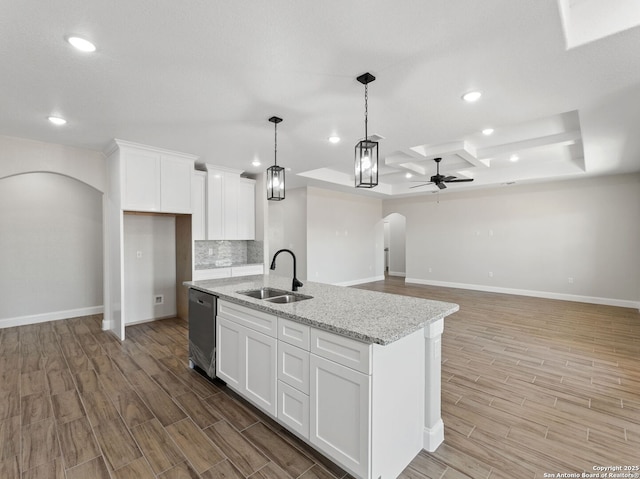 52 Peach Tree, Poteet, TX 78065 - kitchen featuring arched walkways, a sink, ceiling fan, light wood-style flooring, and baseboards