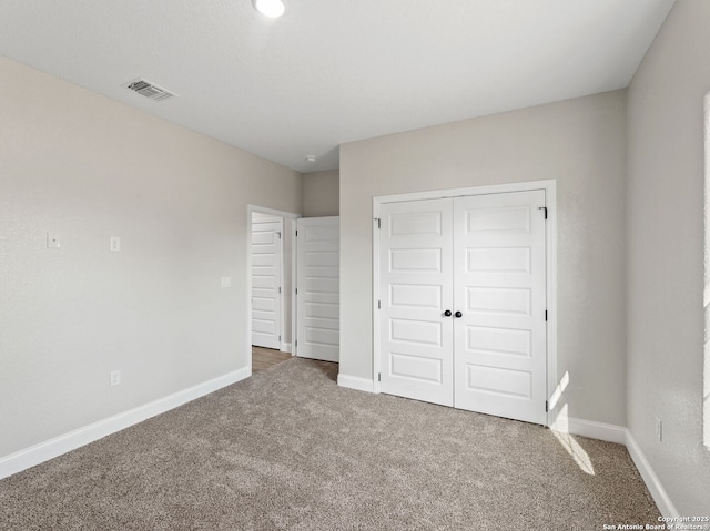 52 Peach Tree, Poteet, TX 78065 - unfurnished bedroom with carpet floors, baseboards, and a closet