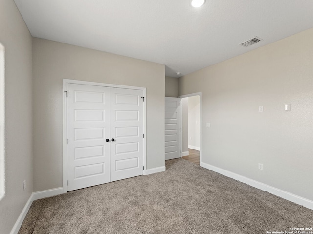 52 Peach Tree, Poteet, TX 78065 - unfurnished bedroom featuring carpet floors, a closet, and baseboards