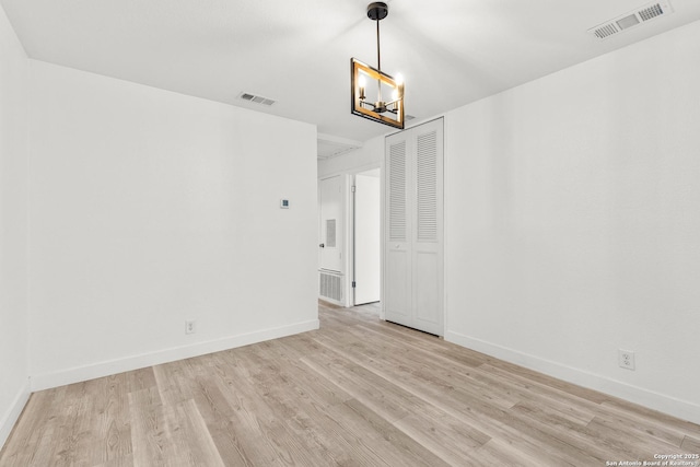 4419 El Simpatico, San Antonio, TX 78233 - empty room featuring light wood-style flooring, a chandelier, and baseboards