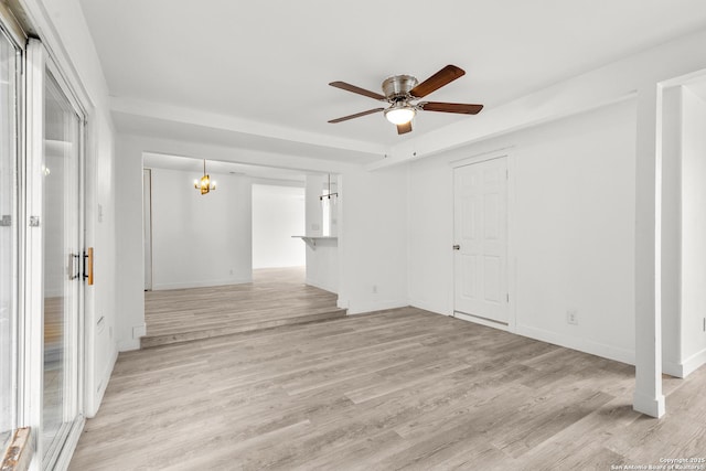 4419 El Simpatico, San Antonio, TX 78233 - empty room featuring ceiling fan, light wood-style flooring, baseboards, and a chandelier