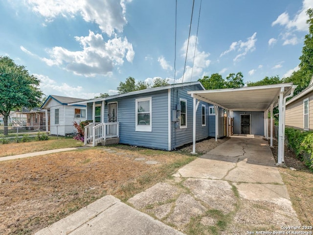 815 Flanders, San Antonio, TX 78211 - view of front facade with concrete driveway and a carport