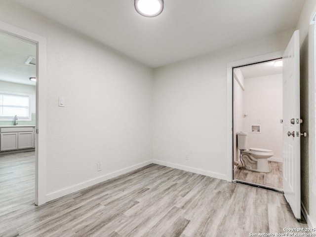 815 Flanders, San Antonio, TX 78211 - spare room with light wood-type flooring, baseboards, and a sink