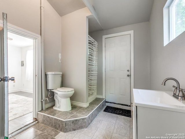 815 Flanders, San Antonio, TX 78211 - bathroom with toilet, vanity, tile patterned flooring, and baseboards