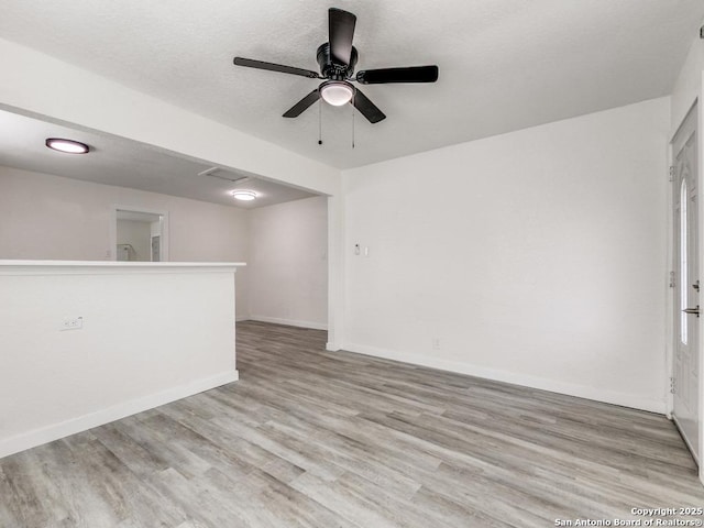 815 Flanders, San Antonio, TX 78211 - unfurnished living room featuring light wood-style flooring, baseboards, and a ceiling fan