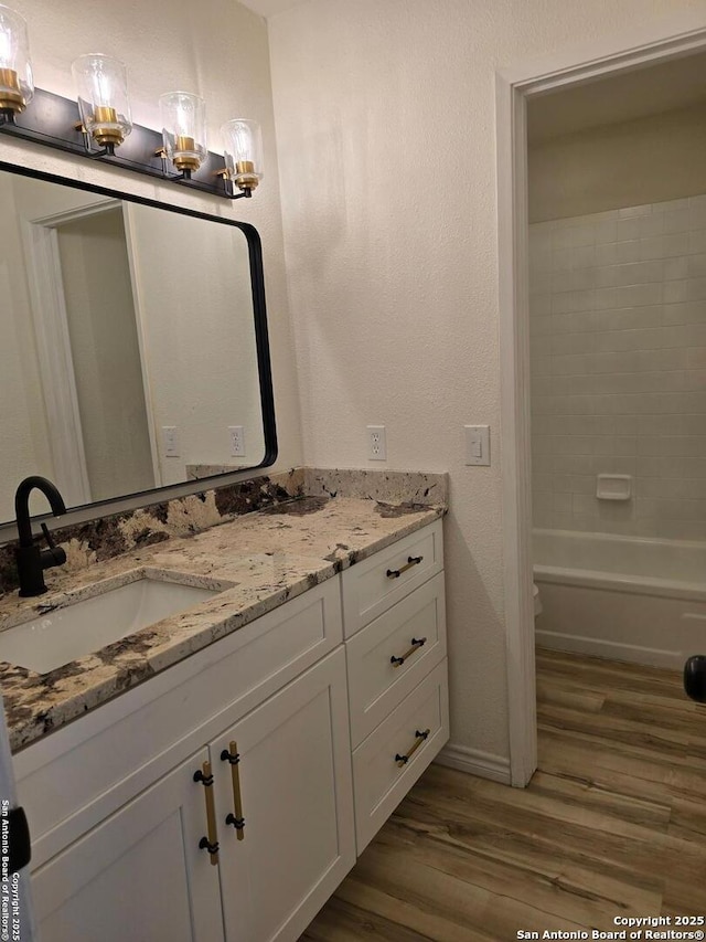 7401 Old Spanish Trl, Live Oak, TX 78233 - full bathroom with double vanity, wood finished floors, and baseboards