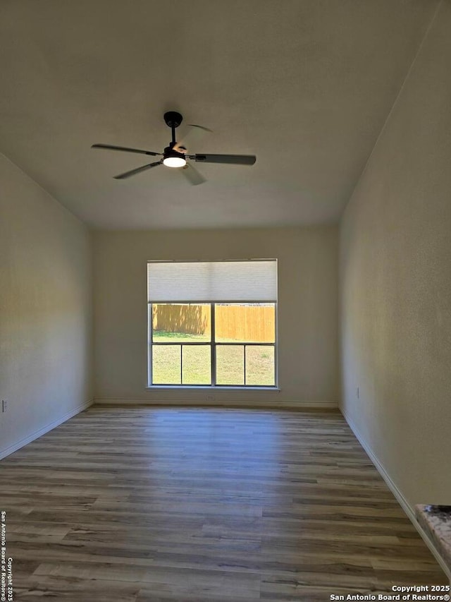 7401 Old Spanish Trl, Live Oak, TX 78233 - spare room featuring wood finished floors, baseboards, and ceiling fan