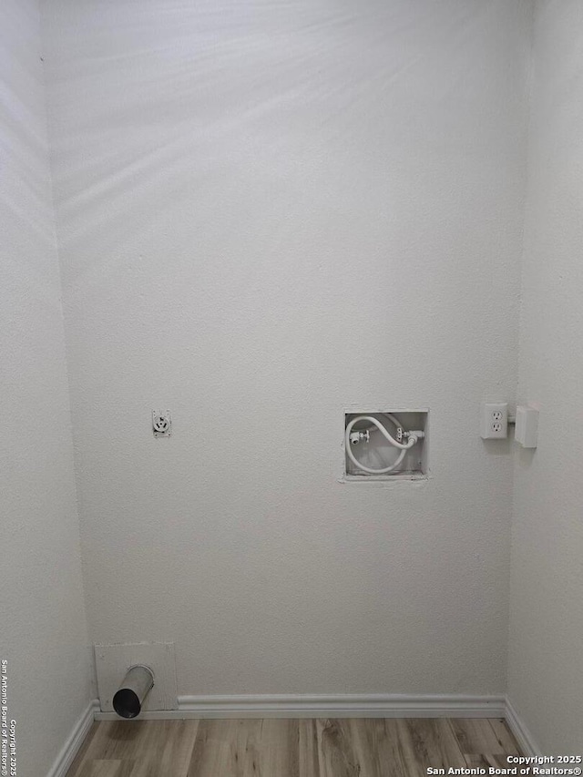 7401 Old Spanish Trl, Live Oak, TX 78233 - laundry area with wood finished floors, baseboards, and hookup for a washing machine