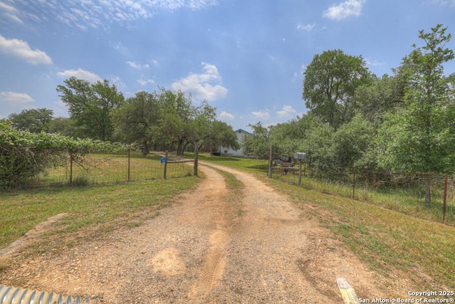 163 Eden Rnch, Canyon Lake, TX 78133 - view of dirt / gravel driveway with a gated entry