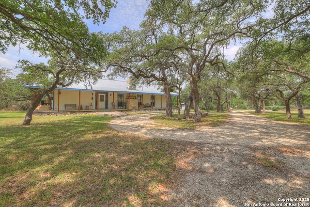 163 Eden Rnch, Canyon Lake, TX 78133 - back of property featuring a porch, metal roof, and a lawn