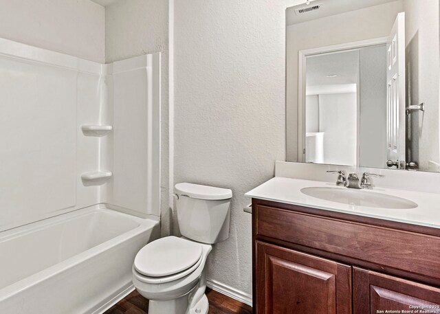 3175 Wild Indigo, New Braunfels, TX 78130 - full bath featuring a textured wall, vanity, toilet, wood finished floors, and tub / shower combination