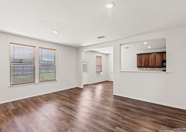 3175 Wild Indigo, New Braunfels, TX 78130 - unfurnished living room with dark wood-style floors, baseboards, and recessed lighting