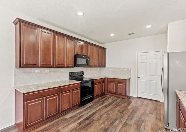 3175 Wild Indigo, New Braunfels, TX 78130 - kitchen with black appliances, dark wood-type flooring, backsplash, light stone counters, and recessed lighting
