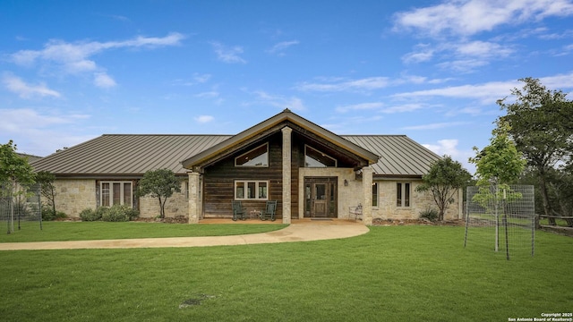 121 N Spanish Oak Trl, Kerrville, TX 78028 - view of front of home featuring a standing seam roof, stone siding, metal roof, and a front yard