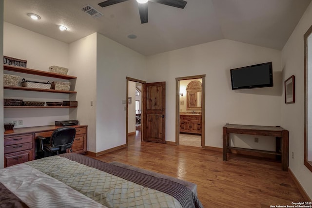 121 N Spanish Oak Trl, Kerrville, TX 78028 - bedroom featuring light wood-style floors, baseboards, lofted ceiling, ensuite bathroom, and a ceiling fan