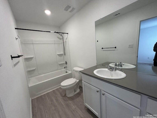 614 Agave, Jourdanton, TX 78026 - full bath featuring wood finished floors, vanity, toilet, and shower / bath combination