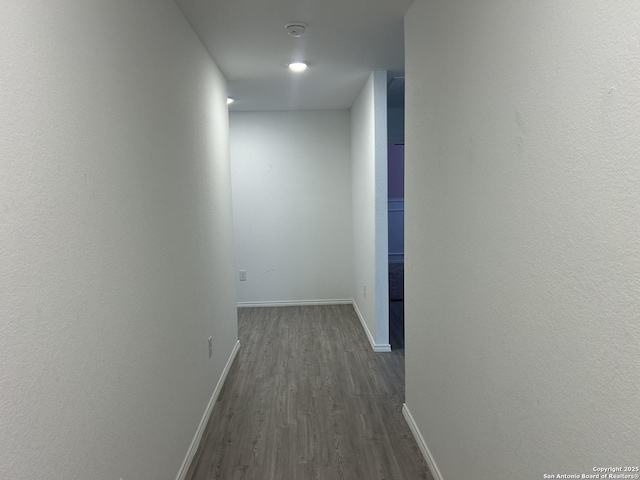 614 Agave, Jourdanton, TX 78026 - hallway with dark wood-type flooring and baseboards