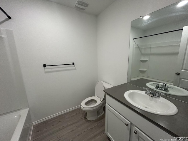 614 Agave, Jourdanton, TX 78026 - full bath featuring wood finished floors, vanity, toilet, and baseboards