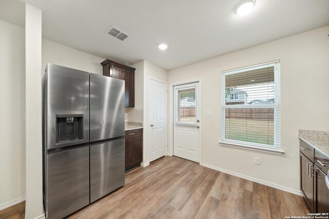 7341 Yucca Pl, San Antonio, TX 78253 - kitchen with stainless steel fridge with ice dispenser, dark brown cabinetry, light wood-style flooring, baseboards, and recessed lighting