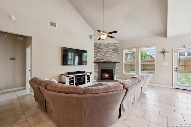 32003 Cast Iron, Bulverde, TX 78163 - living area featuring a ceiling fan, light tile patterned floors, plenty of natural light, a stone fireplace, and high vaulted ceiling