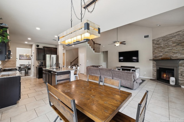32003 Cast Iron, Bulverde, TX 78163 - dining space with light tile patterned flooring, stairs, a fireplace, ceiling fan, and recessed lighting