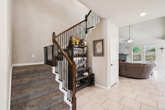 32003 Cast Iron, Bulverde, TX 78163 - stairway with ceiling fan, a warm lit fireplace, baseboards, high vaulted ceiling, and tile patterned flooring