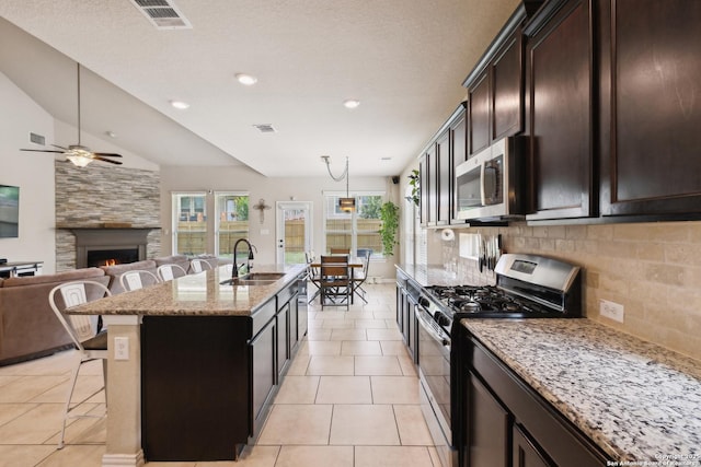 32003 Cast Iron, Bulverde, TX 78163 - kitchen featuring stainless steel appliances, a sink, a kitchen bar, open floor plan, and a ceiling fan