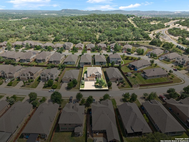 32003 Cast Iron, Bulverde, TX 78163 - aerial view of property and surrounding area with nearby suburban area and a mountainous background
