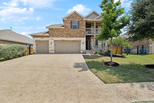32003 Cast Iron, Bulverde, TX 78163 - view of front of house with concrete driveway, stone siding, a balcony, a porch, and a shingled roof