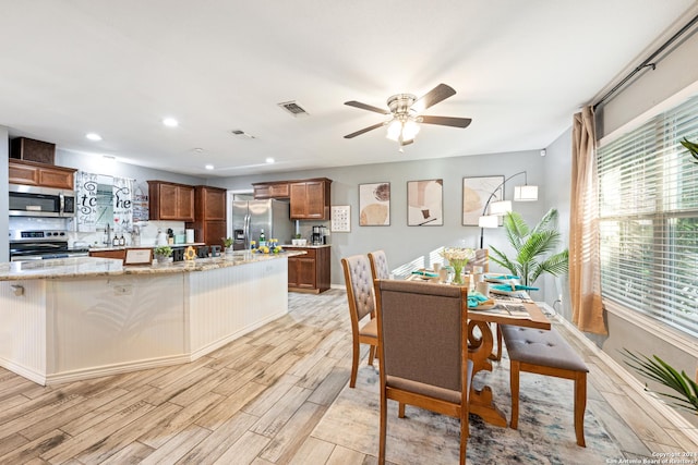 5802 Branch Vly, San Antonio, TX 78242 - dining room with light wood-style floors, a ceiling fan, plenty of natural light, recessed lighting, and baseboards