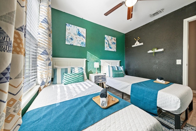 5802 Branch Vly, San Antonio, TX 78242 - bedroom with wood finished floors, an accent wall, and a ceiling fan