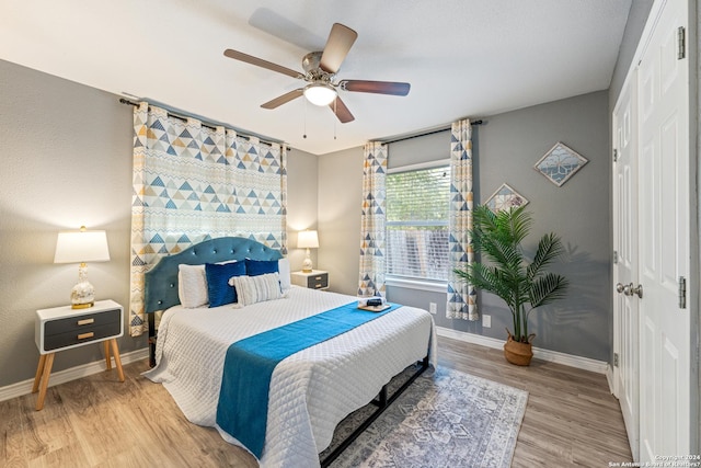 5802 Branch Vly, San Antonio, TX 78242 - bedroom featuring a closet, baseboards, wood finished floors, and a ceiling fan