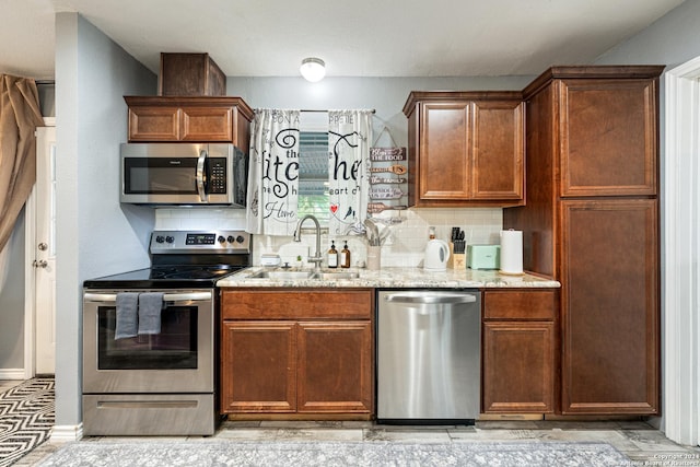 5802 Branch Vly, San Antonio, TX 78242 - kitchen featuring stainless steel appliances, a sink, light stone countertops, and decorative backsplash